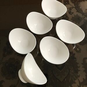 Six small oval serving bowls.
